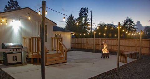 Spacious back patio with bench seating & fire pit