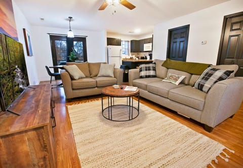 Lounge in our spacious living room that opens up to a modern kitchen, ideal for family time or a get-together with friends.