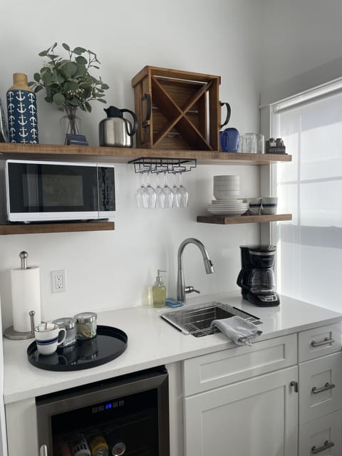 Upstairs kitchenette, coffee maker, beverage fridge, microwave, sink