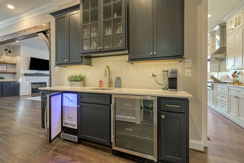 Well appointed bar area with prep sink, icemaker and beverage fridge.