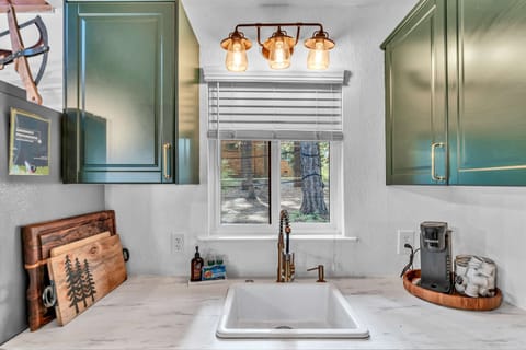 Kitchen: Stainless steel appliances, cooking utensils, kettle, coffee maker, tableware