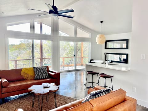 Stunning wooded view and bright natural light in Evergreen's living area. 