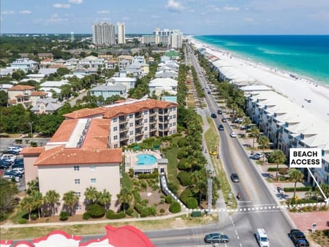 Aerial view showcasing the property's prime beachfront location with direct beach access and stunning white sand coastline nearby.