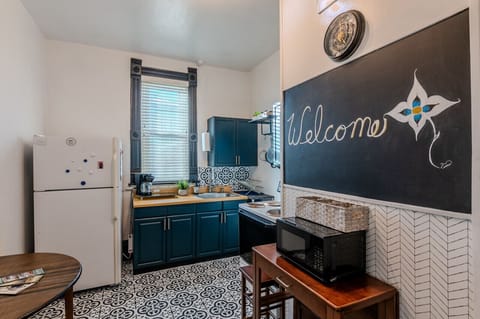 Full kitchen with large fridge, oven, toaster oven and microwave