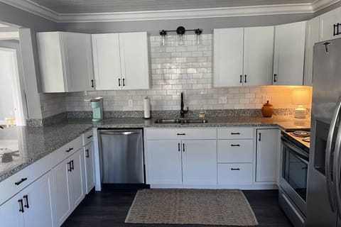 Fully stocked kitchen has ample dishes, glasses, silverware, bowls, pots and pans for quick food on the run or full meals.