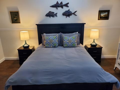 Large master bedroom with queen sized bed and walk in closet.