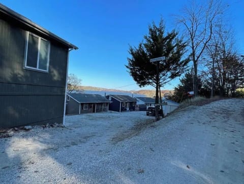 Entrance to gravel parking area outside of home.