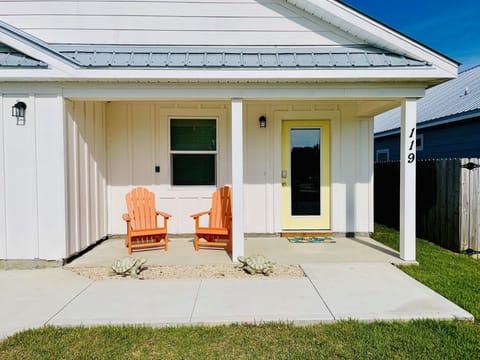 two adirondack chairs on the front patio