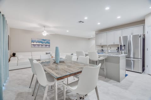 Spacious Dining Area with Adjacent Bar Stools for Additional Seating