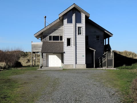 PELICAN WATCH FROM THE STREET LOOKING WEST TO THE OCEAN OVER THE DUNE.