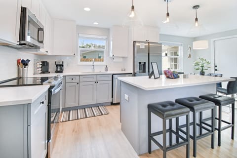 Fully stocked kitchen w/ all your cooking needs plus an island w/ seating for 3