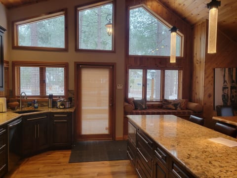 View of kitchen and window seat from hallway.