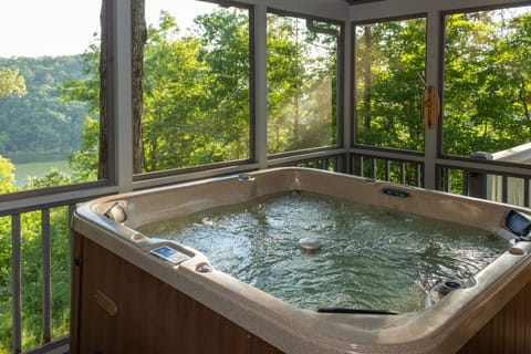 Relax in our 5 person hot tub inside a fully screened in porch.