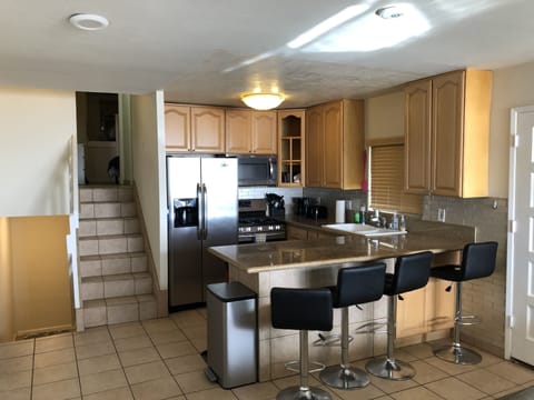 Kitchen is in granite, wood & stainless steel. It has all appliances & cookware.