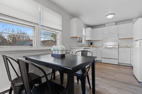 Fully furnished kitchen with dining area seating.