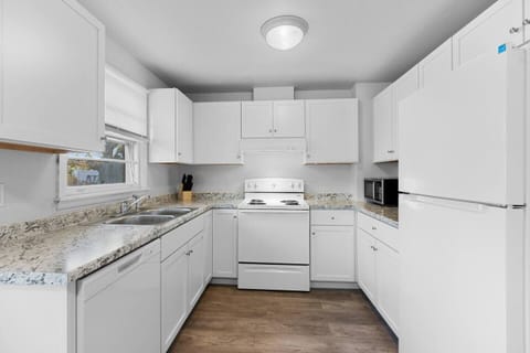Fully furnished kitchen with dining area seating.