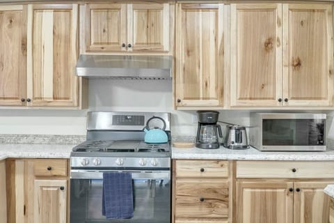 Kitchen stove is gas-operated and includes a middle griddle burner.