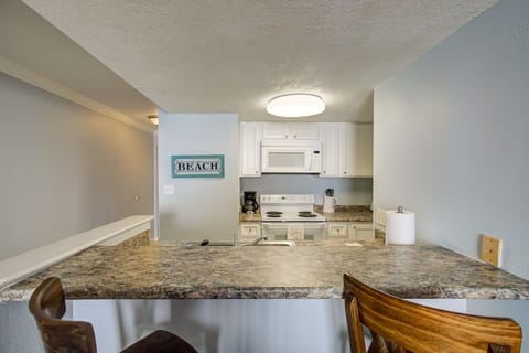 Kitchen bar accommodates seating for two. 