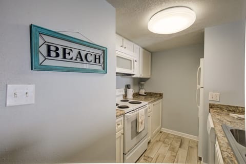 Kitchen is stocked with pots/pans/utensils. 