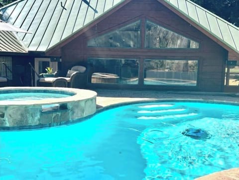 Solarium overlooks the pool and hot tub for guests watching outside activities