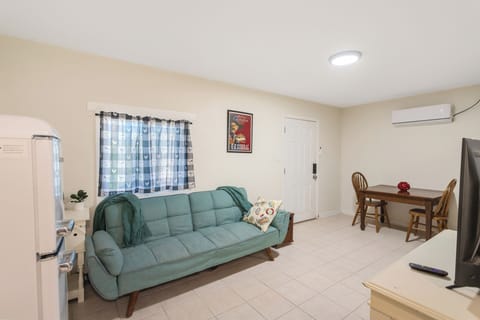 living room with roku tv and futon