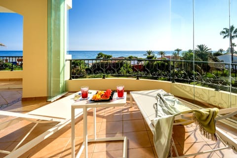 Large south facing seaview terrace with sunbeds, sofa, table, chairs.