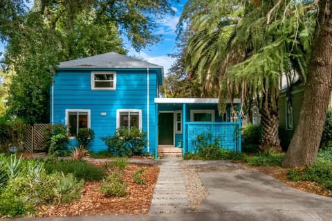 Front of the 2 story house with one parking space in the driveway.