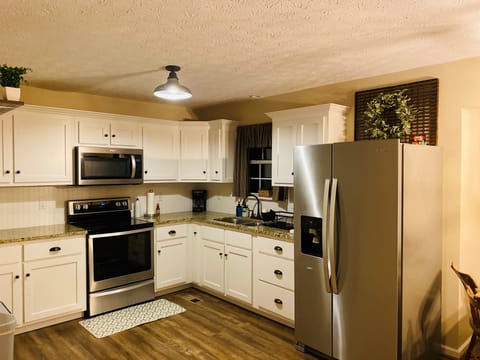 Full kitchen with dinnerware, drinkware, with some seasonings and spices