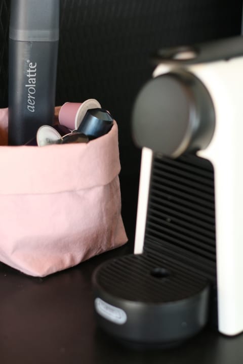 DeLonghi Coffee machine with pods provided.