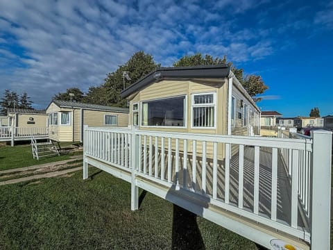 Sunny patio with spacious deck and scenic sky views