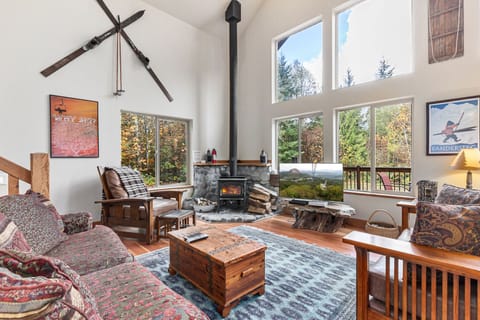 Airy, inviting great room with a wood stove (bundle of pressed logs provided) and comfy furniture beside the kitchen
