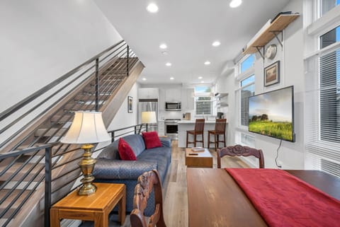 2nd level - kitchen, small dining, and living room with a 55" TV.