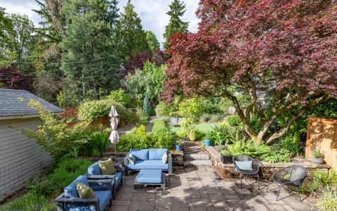 Private backyard garden with 2,800 sq ft of lounge areas, games, and bbq. 