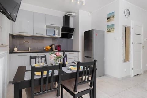 Kitchenette with plenty of kitchen utensils and dishes.