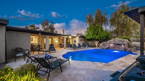 Your private outdoor oasis: sparkling pool, waterfall slide, hot tub & loungers.