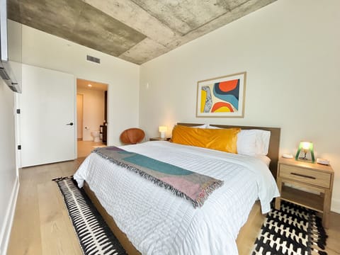 Bedroom with king size bed, firm & plush pillows, darkening shades & ear plugs