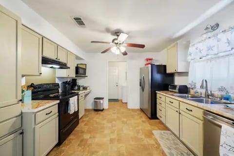 Kitchen looking towards the back boor/washroom. 