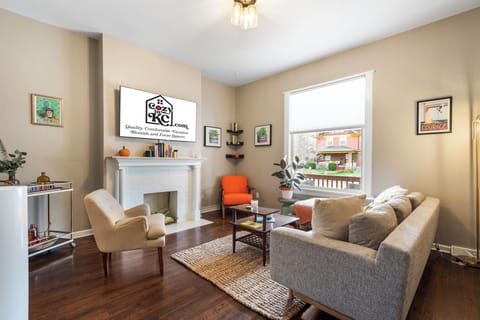 Bright and welcoming living room with Smart TV and mid-century accents—perfect for relaxing after exploring West 39th Street.