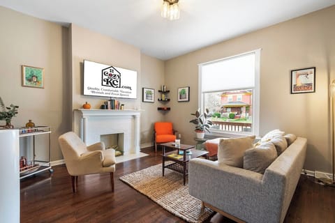 Bright and welcoming living room with Smart TV and mid-century accents—perfect for relaxing after exploring West 39th Street.