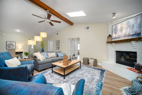 Spacious living room with cozy fireplace and stylish seating for ultimate relaxation~