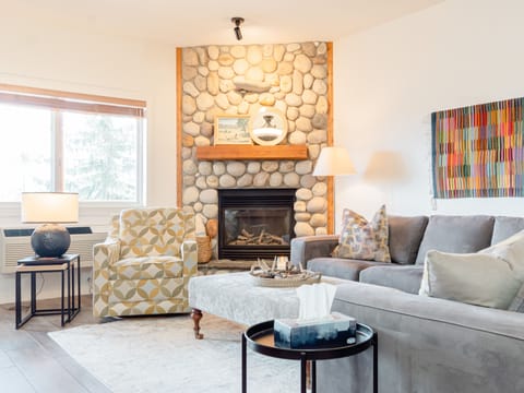 Living room with big comfy sectional and gas fireplace.