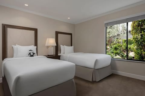 Wake up to soft daylight and leafy views from bed.