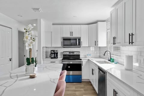 Fully stocked kitchen with quartz countertops, stainless steel appliances, and everything you need to cook at home