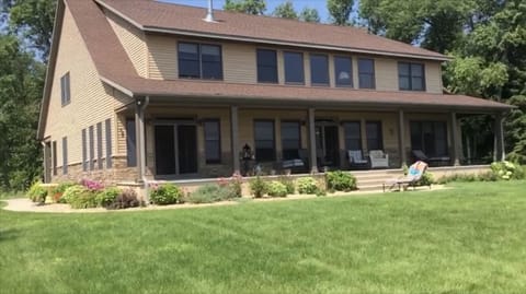 Charming and sunny home surrounded by lush green lawn.
