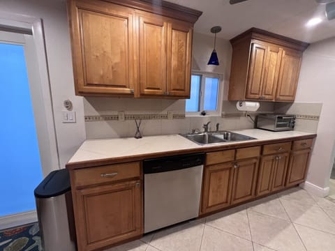 Well appointed kitchen with plenty of dishes, glassware and silverware