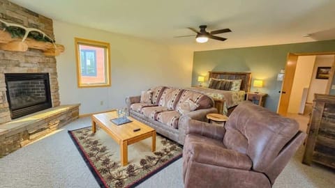 Large Master Suite with queen bed, seating area with pullout, a twin bed, ensuite bathroom and oversized garage