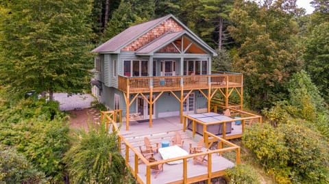Two levels of outdoor living, Adirondack chairs, and a hot tub tucked into the Blue Ridge trees.