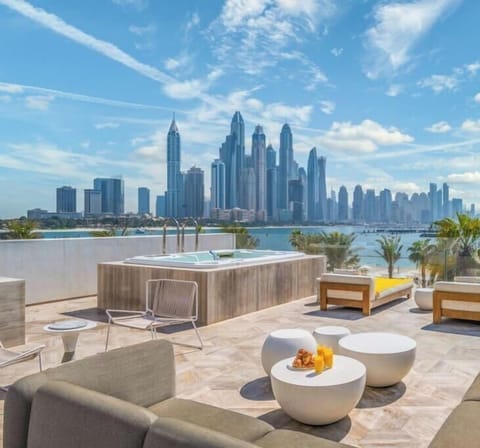 FIVE Palm Beach Villa Top floor with seating, sun beds, bar and large jacuzzi for 8 persons with panoramic views of Dubai marina