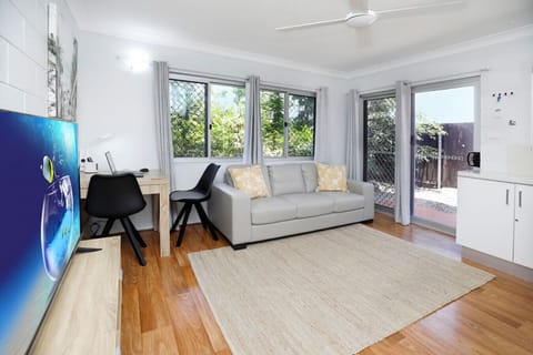 Living Room: Bright and airy space featuring modern decor, a Smart TV, and direct patio access!