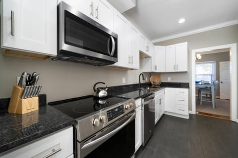 Fully equipped kitchen with granite countertops and stainless steel appliances.